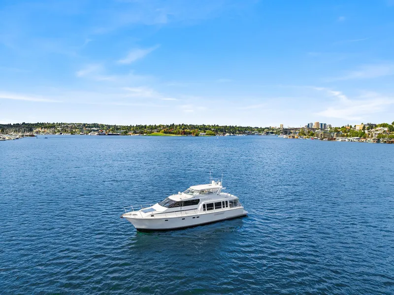 Slide: The Image of 2003 Pacific Mariner Pilothouse yacht cruising on a serene blue lake under a clear sky. - 49