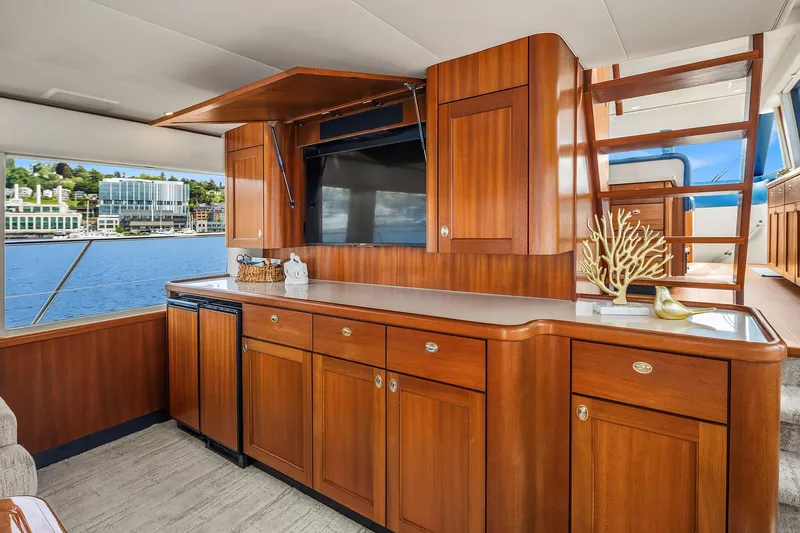 Slide: The Image of Luxurious 2003 Pacific Mariner Pilothouse interior with elegant wood cabinetry and waterfront view. - 7
