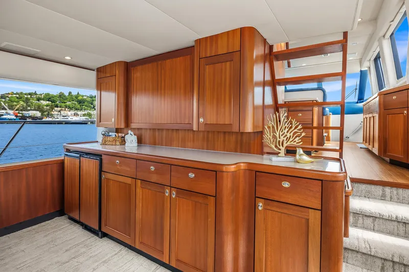 Slide: The Image of Luxurious 2003 Pacific Mariner Pilothouse interior with elegant wood cabinetry and scenic water view. - 8