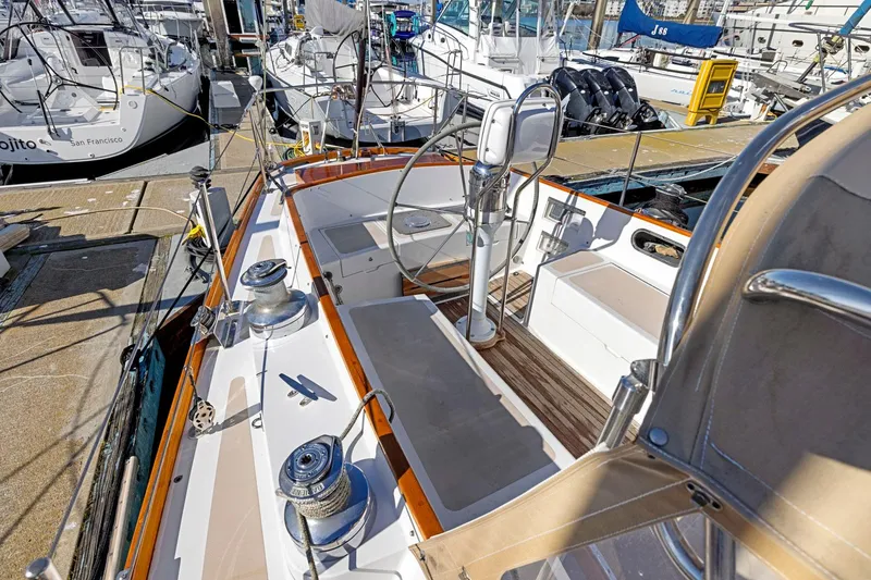 Slide: The Image of 1987 Hinckley Sou'wester 42 sailboat cockpit with steering wheel, docked at marina. - 13