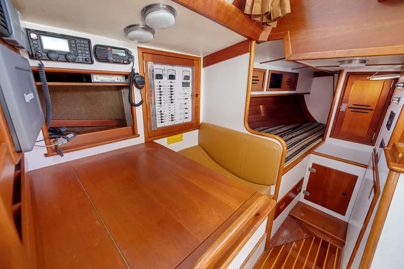 Slide: The Image of Interior of 1987 Hinckley Sou'wester 42 sailboat with navigation equipment and wooden furnishings. - 26