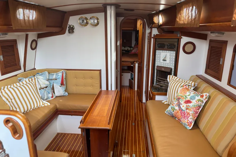 Slide: The Image of Interior of 1987 Hinckley Sou'wester 42 yacht with wooden furnishings and colorful cushions. - 34
