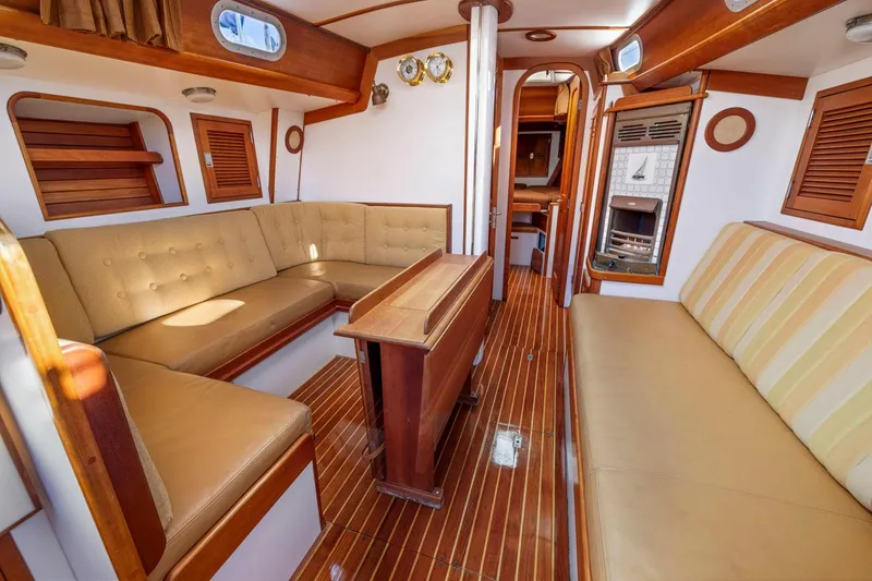 Slide: The Image of Interior of 1987 Hinckley Sou'wester 42 yacht with wooden accents and beige seating. - 37