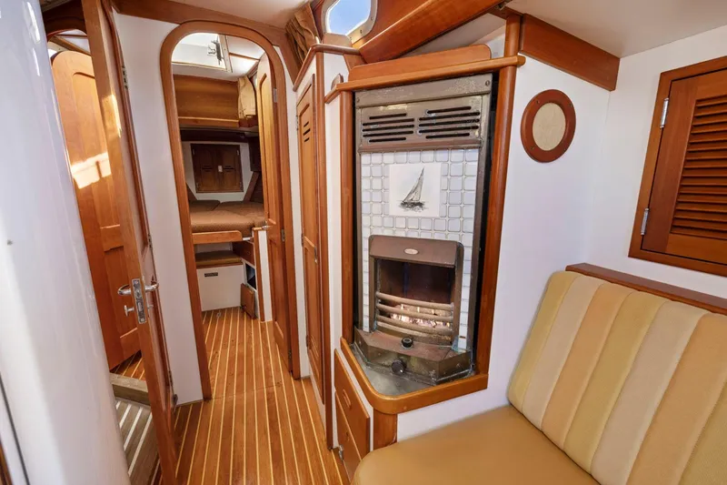 Slide: The Image of Interior of 1987 Hinckley Sou'wester 42 sailboat with wood paneling and cozy seating. - 42