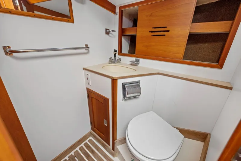 Slide: The Image of Hinckley Sou'wester 42 yacht bathroom, 1987 model, featuring wooden cabinetry and compact design. - 43