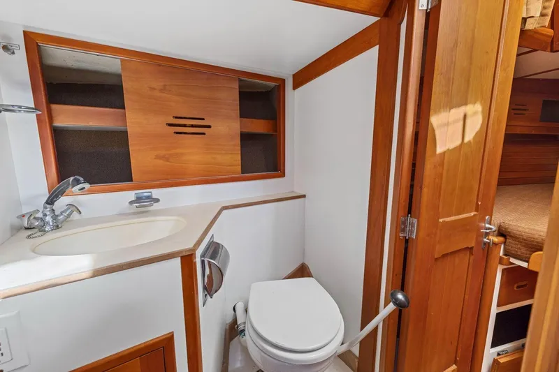 Slide: The Image of 1987 Hinckley Sou'wester 42 yacht bathroom with wooden cabinetry and compact design. - 44