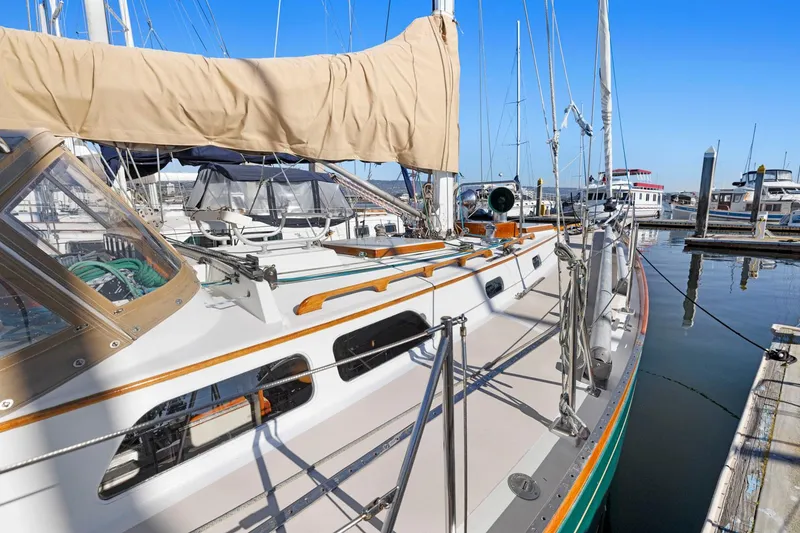 Slide: The Image of Hinckley Sou'wester 42 sailboat, 1987 model, docked at marina under clear blue sky. - 6