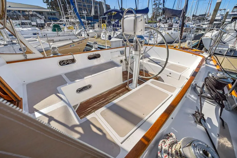Slide: The Image of 1987 Hinckley Sou'wester 42 sailboat cockpit with steering wheel, docked in marina. - 14