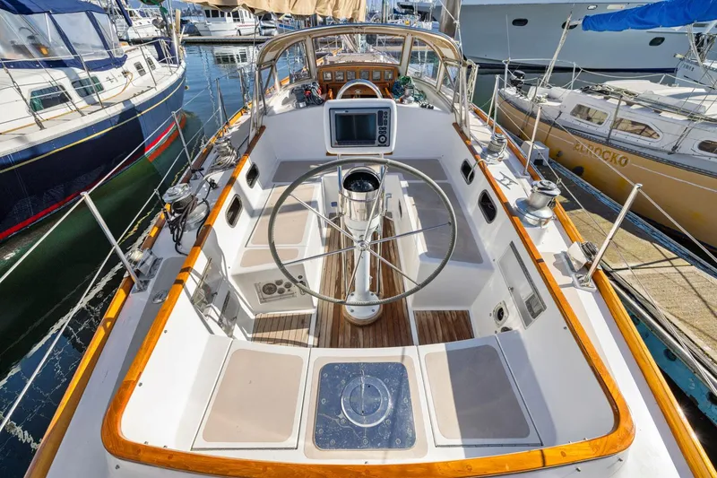 Slide: The Image of Cockpit of 1987 Hinckley Sou'wester 42 sailboat with steering wheel and navigation equipment. - 16