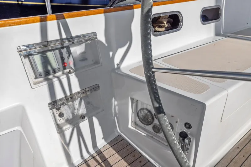 Slide: The Image of Cockpit of 1987 Hinckley Sou'wester 42 sailboat with steering wheel and control panels. - 18