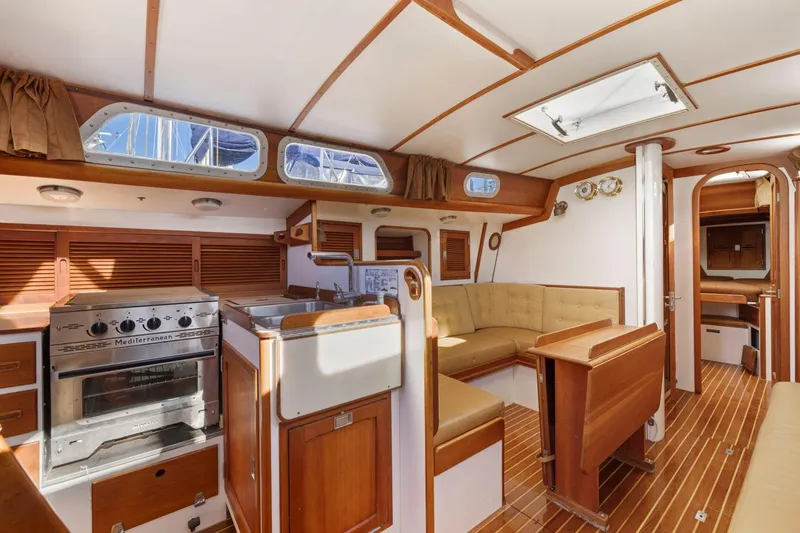 Slide: The Image of Interior of 1987 Hinckley Sou'wester 42 sailboat with wood finish and cozy seating area. - 30