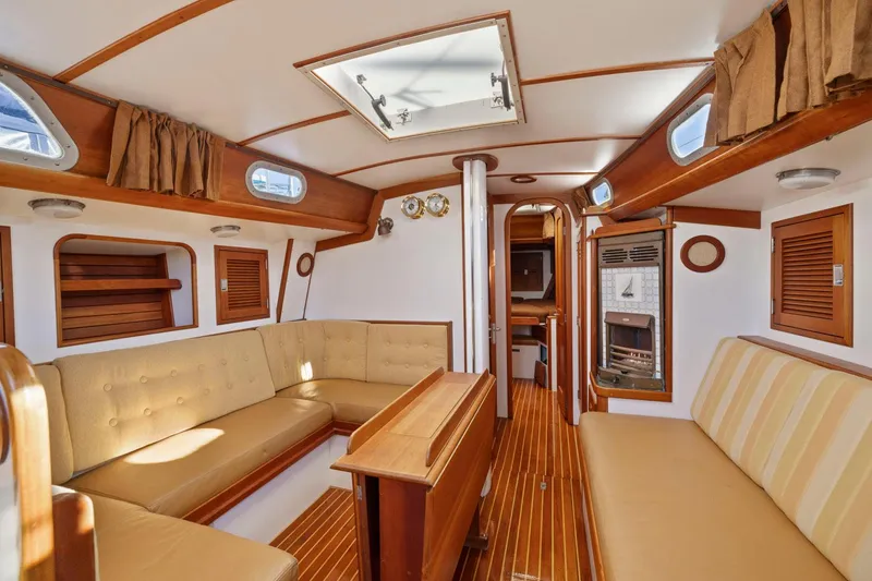 Slide: The Image of Interior of 1987 Hinckley Sou'wester 42 yacht with elegant wood finish and beige seating. - 33