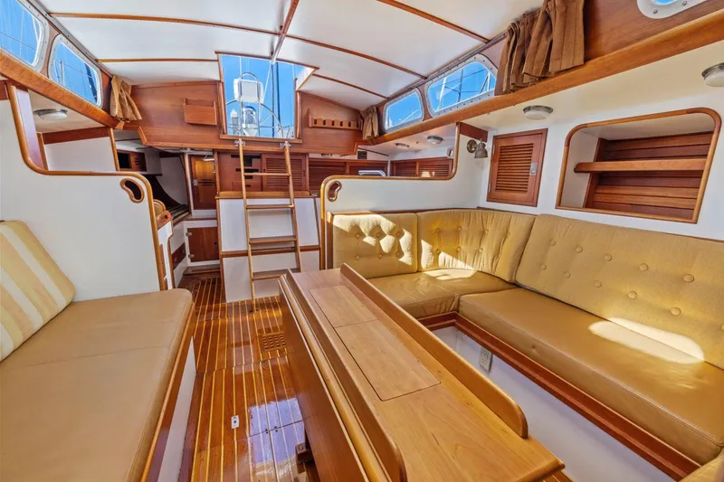 Slide: The Image of Interior of 1987 Hinckley Sou'wester 42 yacht with wooden finishes and beige seating. - 40