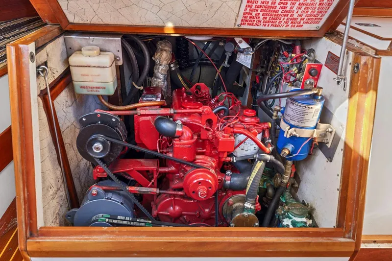 Slide: The Image of Engine compartment of a 1987 Hinckley Sou'wester 42 sailboat, featuring a red marine engine. - 45