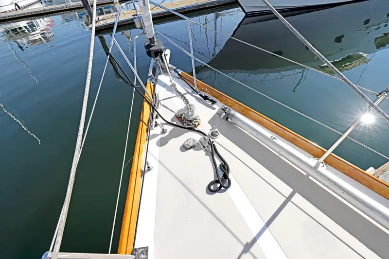 Slide: The Image of Hinckley Sou'wester 42 sailboat deck, 1987 model, docked with visible rigging and reflections. - 8