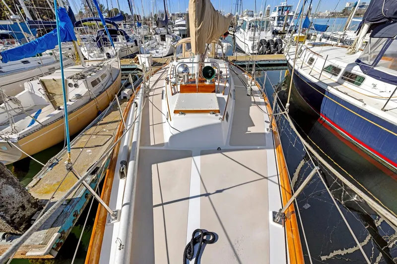Slide: The Image of 1987 Hinckley Sou'wester 42 sailboat docked among other boats in a marina. - 9