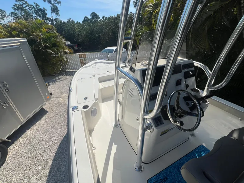 Slide: The Image of 2021 Key West 210 Bay Reef boat with console and steering wheel, parked outdoors. - 14