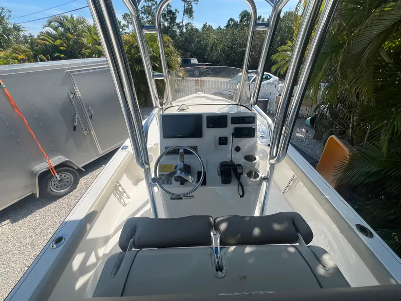 Slide: The Image of 2021 Key West 210 Bay Reef boat interior with steering console and seating. - 15