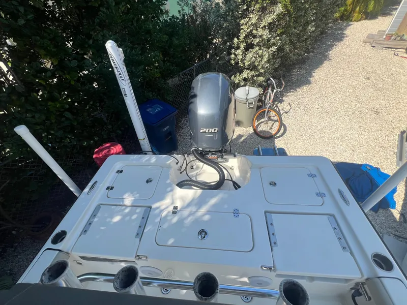 Slide: The Image of 2021 Key West 210 Bay Reef boat with 200 HP engine, parked outdoors. - 17