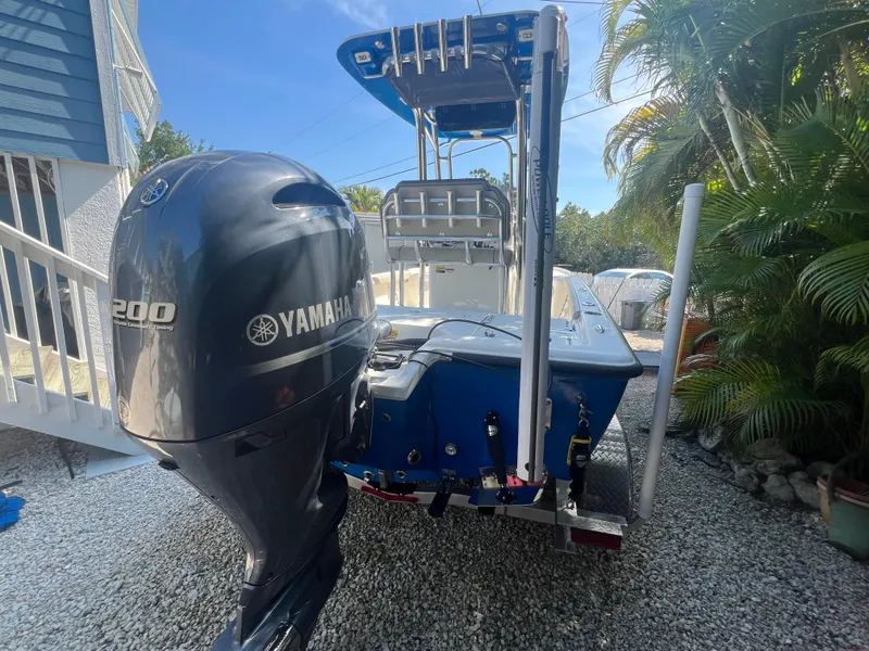 Slide: The Image of 2021 Key West 210 Bay Reef boat with Yamaha 200 engine, parked outdoors. - 3