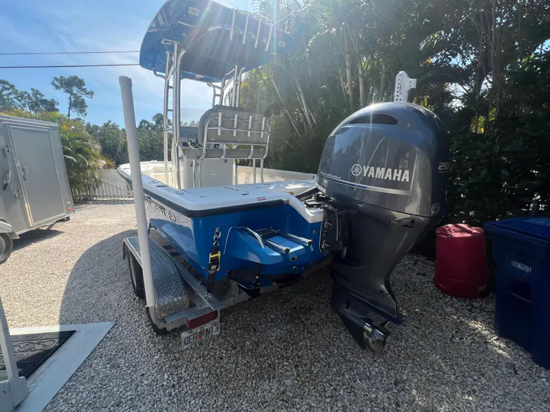 Slide: The Image of 2021 Key West 210 Bay Reef boat with Yamaha outboard motor on a trailer. - 4