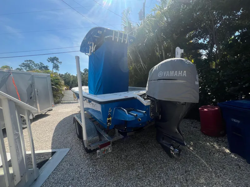 Slide: The Image of 2021 Key West 210 Bay Reef boat with Yamaha motor on trailer, parked outdoors. - 8