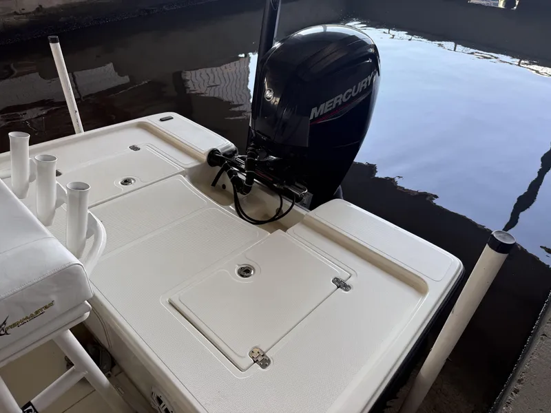 Slide: The Image of 2021 Mako 18 LTS boat with Mercury outboard motor in dock. - 18