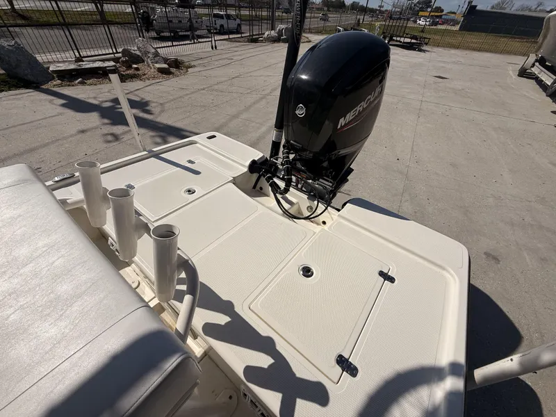 Slide: The Image of 2021 Mako 18 LTS boat with Mercury outboard motor, docked outdoors. - 3