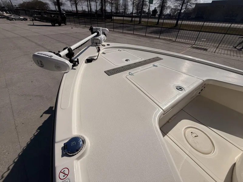 Slide: The Image of 2021 Mako 18 LTS boat deck with trolling motor and storage compartments. - 8