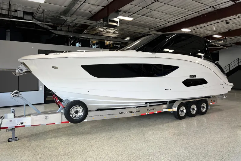 The Image of 2025 Sea Ray Sundancer 370 Outboard yacht docked on clear blue water. - 0