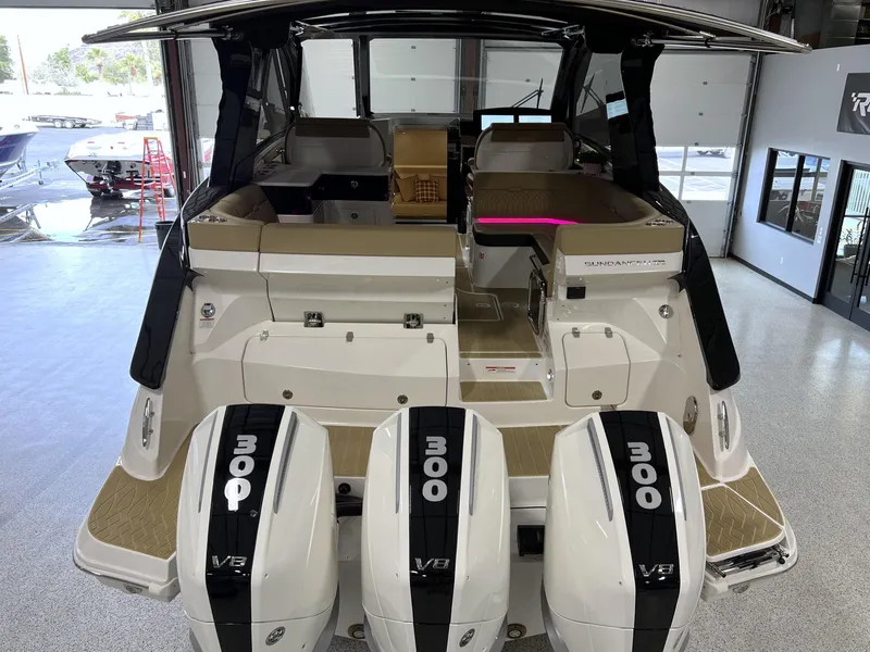 Slide: The Image of 2025 Sea Ray Sundancer 370 OB with triple 300 HP outboard engines in showroom. - 13
