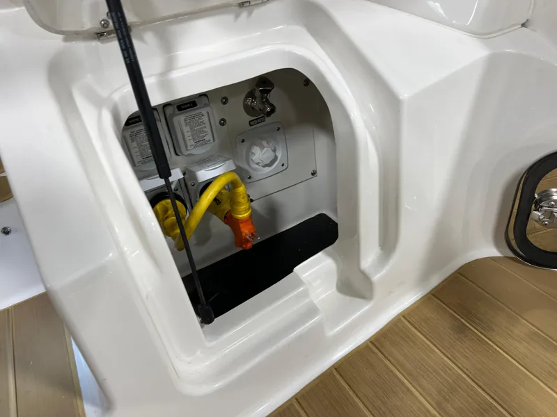 Slide: The Image of 2025 Sea Ray Sundancer 370 OB deck detail with stainless steel fixtures and wood finish. - 17