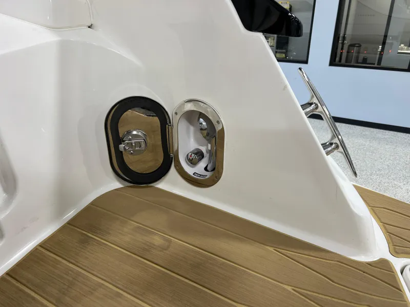 Slide: The Image of 2025 Sea Ray Sundancer 370 OB boat interior with seating and storage compartments. - 18