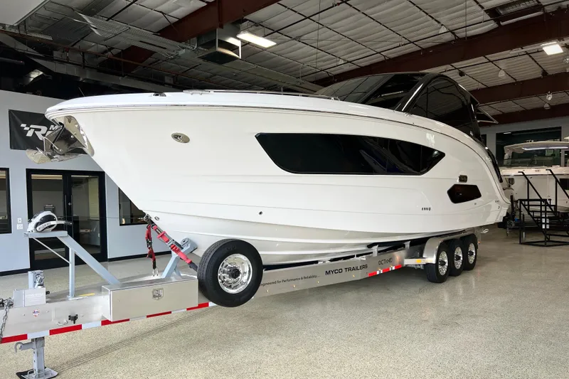 Slide: The Image of 2025 Sea Ray Sundancer 370 Outboard on trailer in a showroom setting. - 2