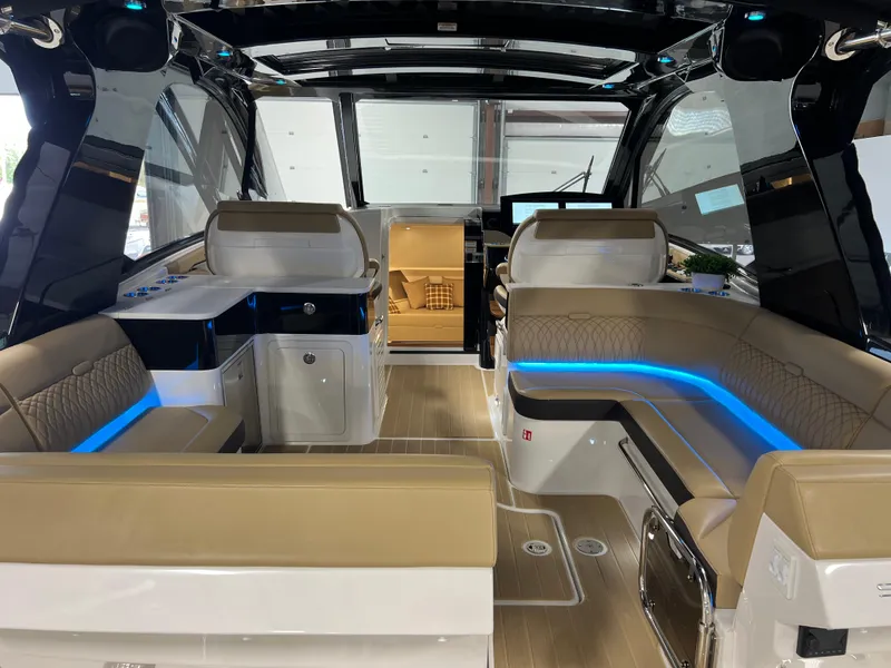 Slide: The Image of Interior of 2025 Sea Ray Sundancer 370 OB, featuring modern seating and sleek design elements. - 21