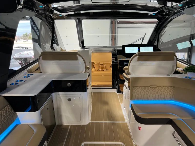 Slide: The Image of 2025 Sea Ray Sundancer 370 OB interior with modern kitchenette and seating area. - 22