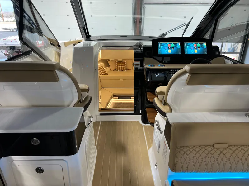 Slide: The Image of 2025 Sea Ray Sundancer 370 OB helm with dual screens and modern controls. - 26