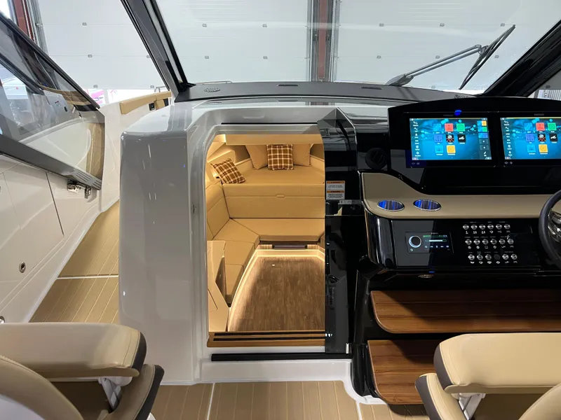 Slide: The Image of Luxurious interior of 2025 Sea Ray Sundancer 370 OB with modern seating and ambient lighting. - 28