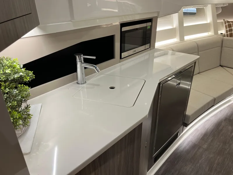 Slide: The Image of 2025 Sea Ray Sundancer 370 OB interior with modern seating and ambient lighting. - 30