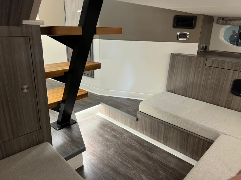 Slide: The Image of 2025 Sea Ray Sundancer 370 OB interior with modern seating and wood accents. - 38