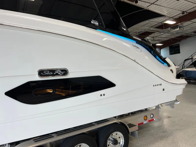 Slide: The Image of 2025 Sea Ray Sundancer 370 OB boat on trailer in showroom. - 4