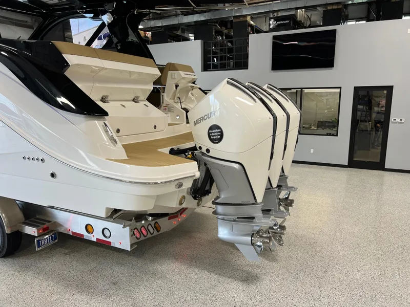 Slide: The Image of 2025 Sea Ray Sundancer 370 OB with triple Mercury outboard engines in showroom. - 6