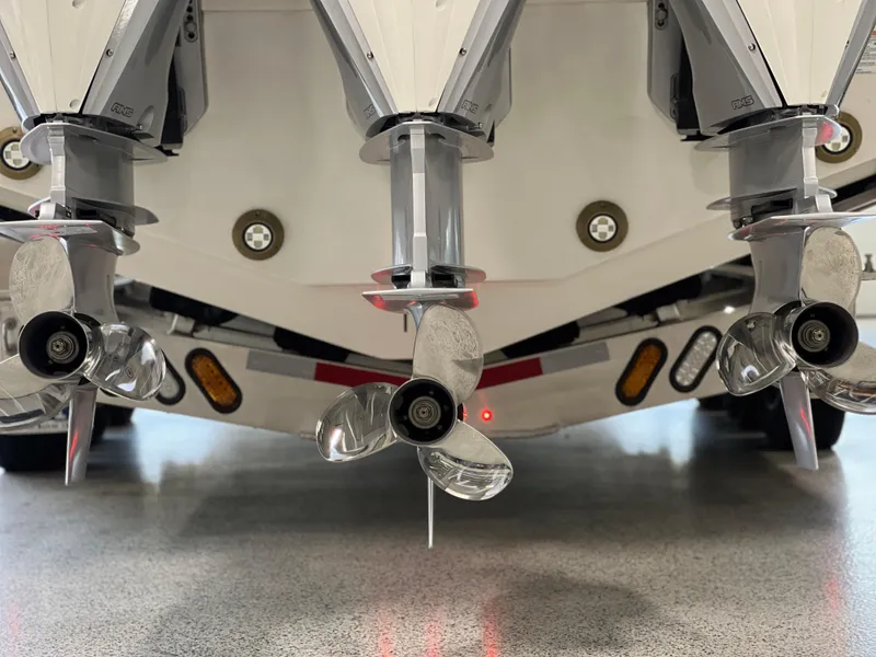 Slide: The Image of 2025 Sea Ray Sundancer 370 OB boat with triple outboard engines and propellers in a showroom. - 8