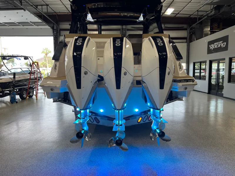 Slide: The Image of 2025 Sea Ray Sundancer 370 OB with triple outboard engines in a showroom. - 9