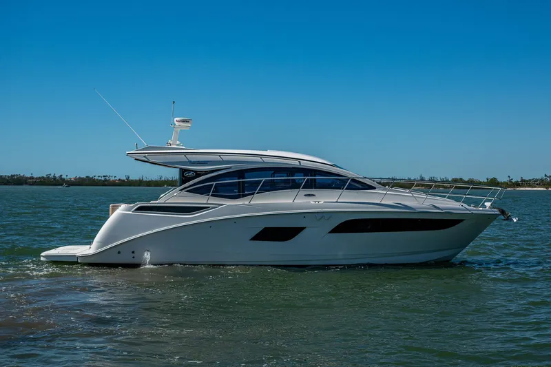 The Image of 2017 Sea Ray Sundancer 400 yacht cruising on calm waters under clear blue sky. - 0
