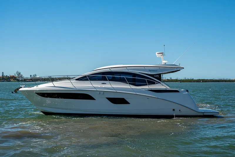 Slide: The Image of 2017 Sea Ray Sundancer 400 yacht cruising on calm waters under a clear blue sky. - 10