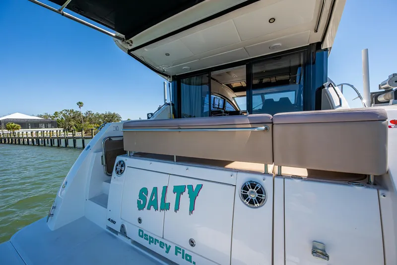 Slide: The Image of 2017 Sea Ray Sundancer 400 yacht docked, featuring "Salty" name on the stern. - 22
