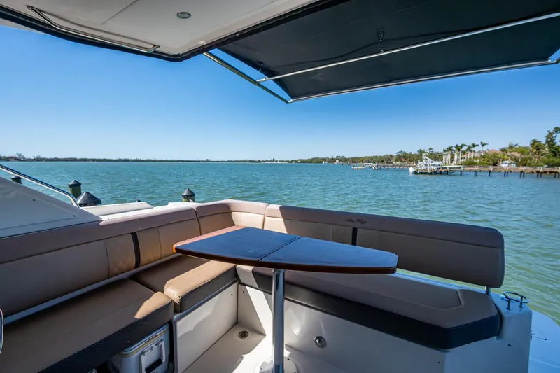 Slide: The Image of Sea Ray Sundancer 400 yacht interior with seating and table, overlooking serene waters. - 26