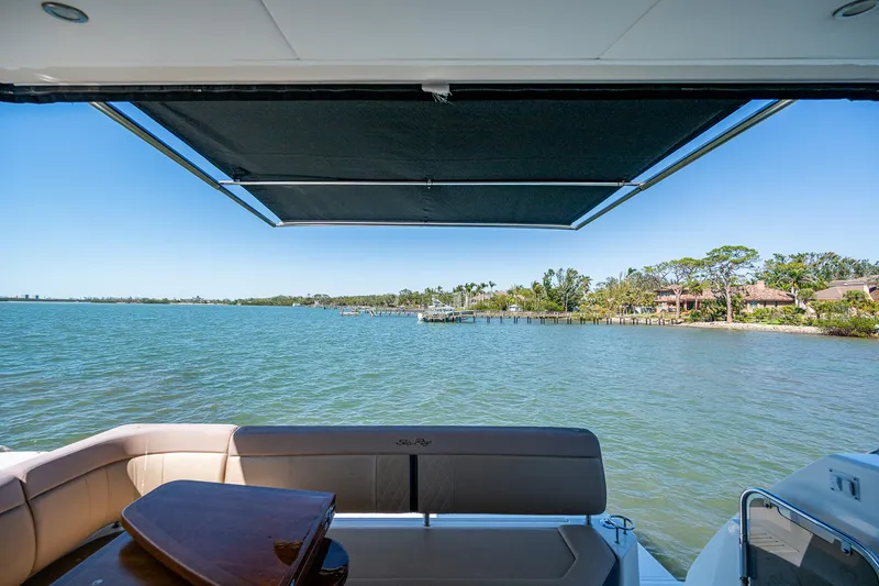 Slide: The Image of Sea Ray Sundancer 400 yacht, 2017 model, with scenic waterfront view and retractable awning. - 27
