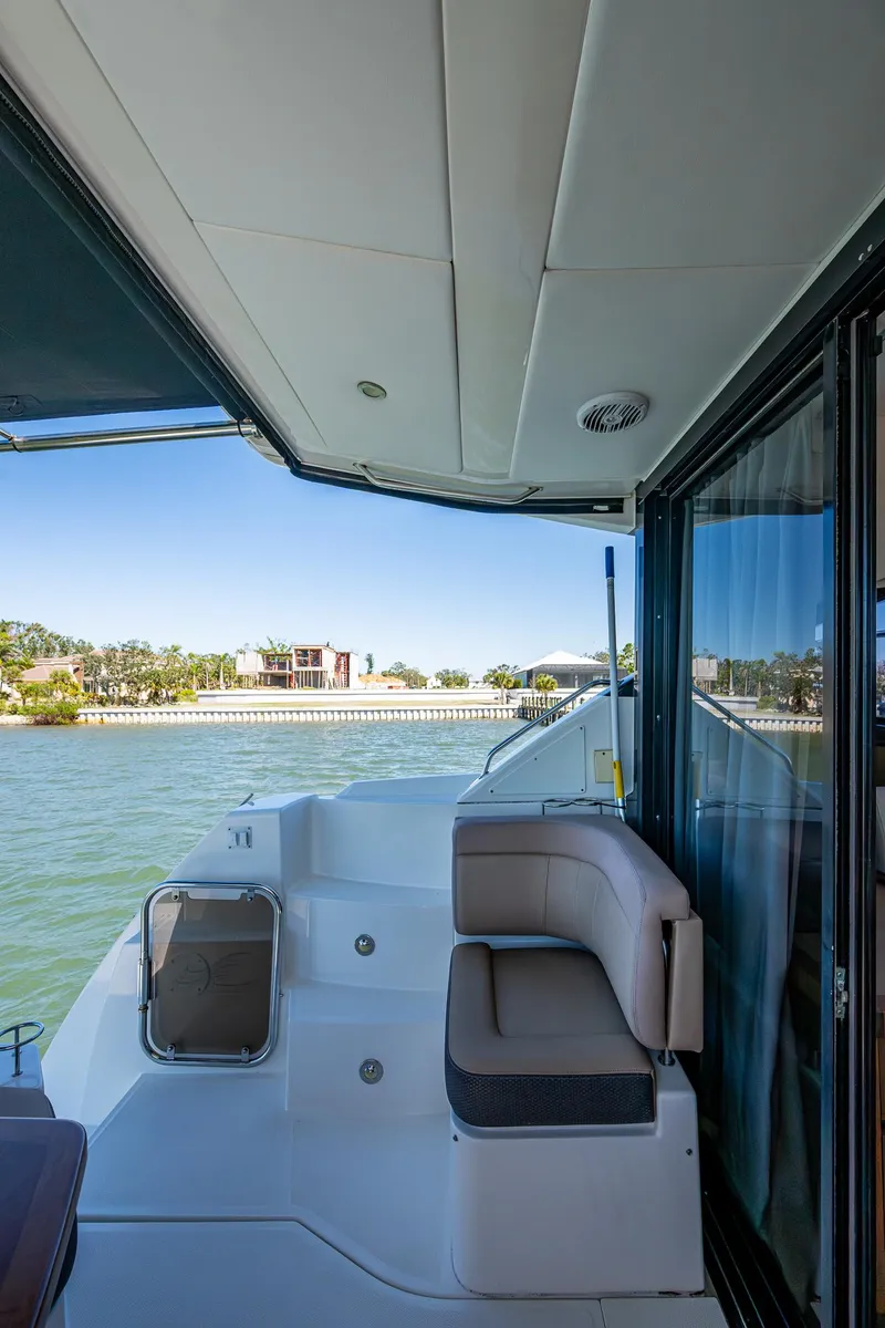 Slide: The Image of 2017 Sea Ray Sundancer 400 yacht deck with seating, overlooking serene waters. - 29